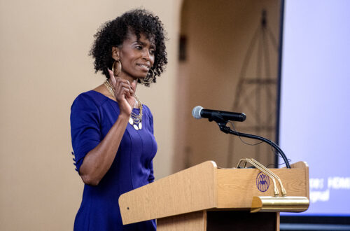 Dr. Markesha Henderson speaks at a podium in Evans Dining Hall.