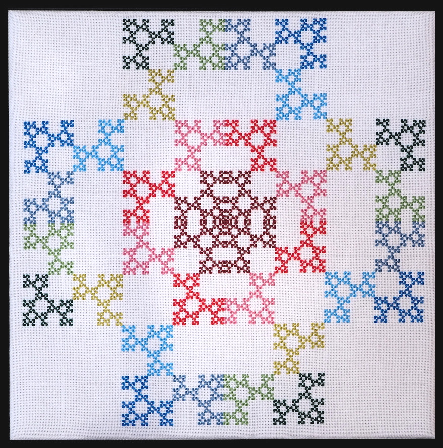 A colorful pattern of cross-stitched triangles and squares. 