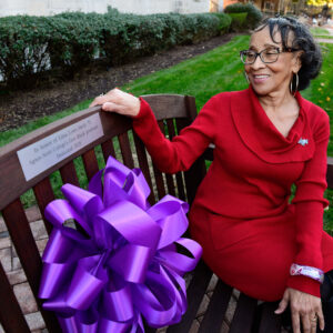 Edna Lowe Swift, Class of 2071 sits on bench dedicated in her honor.