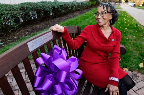 Edna Lowe Swift, Class of 2071 sits on bench dedicated in her honor.