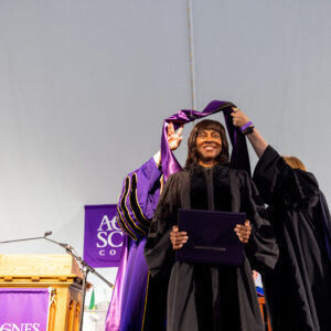 Wonya Lucas receiving her honorary hood and diploma.