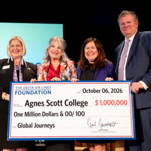 President with Leocadia I. Zak, Gail Grimmett, President & CEO of Delta Flight Museum, and Vice President for College Advancement Cheryl Webster holding a check for one million dollars.